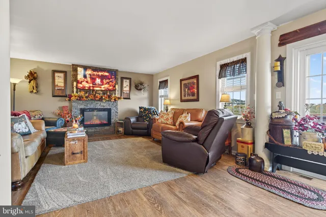 a living room with furniture a flat screen tv and a fireplace