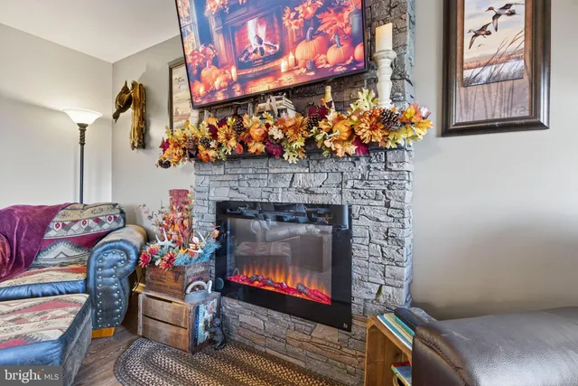 a living room with furniture and a fireplace