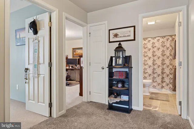 a view of a hallway with wooden floor and closet
