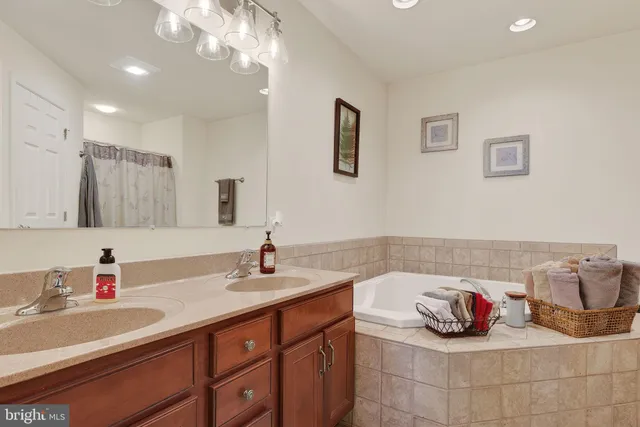 a bathroom with a sink double vanity and a mirror
