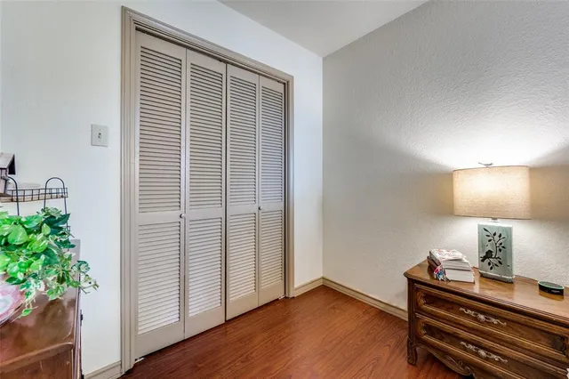 a view of room with window and wooden floor
