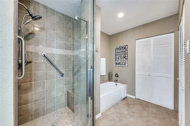 a bathroom with a bathtub and a shower