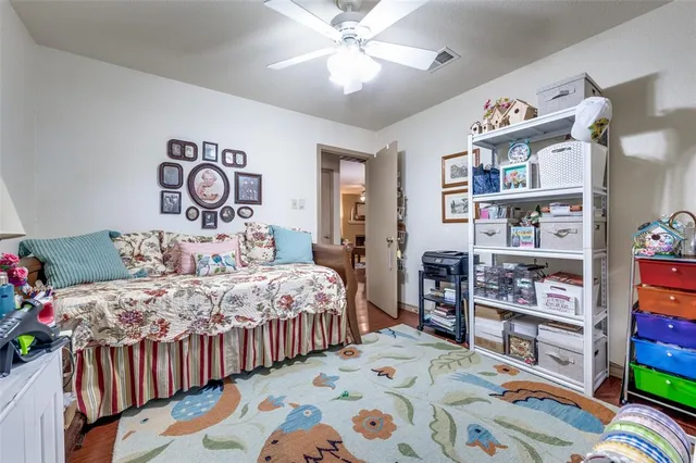 a bedroom with a bed a book shelf and a shelf
