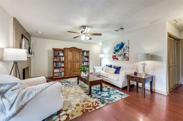 a living room with furniture a rug and a lamp