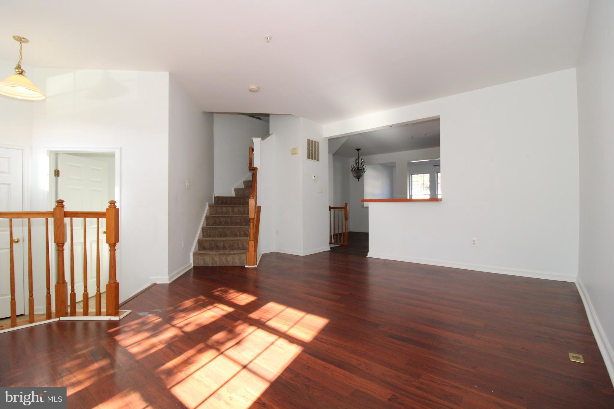 17628 Basalt Way Hagerstown, MD 21740 - Photo 3 of 20 a view of a livingroom with wooden floor and stairs