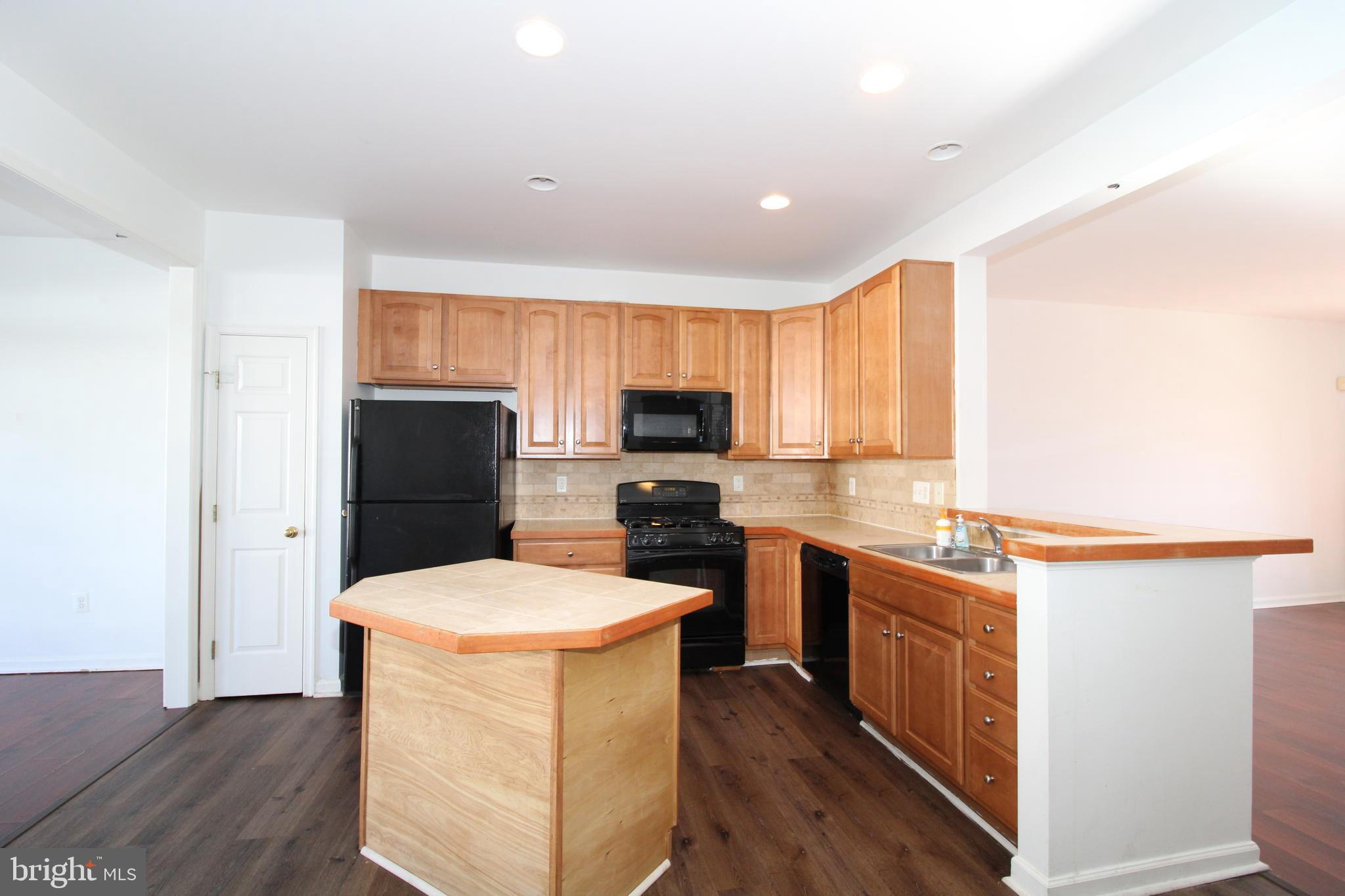 17628 Basalt Way Hagerstown, MD 21740 - Photo 5 of 20 a kitchen with stainless steel appliances a stove top oven a sink a refrigerator and cabinets
