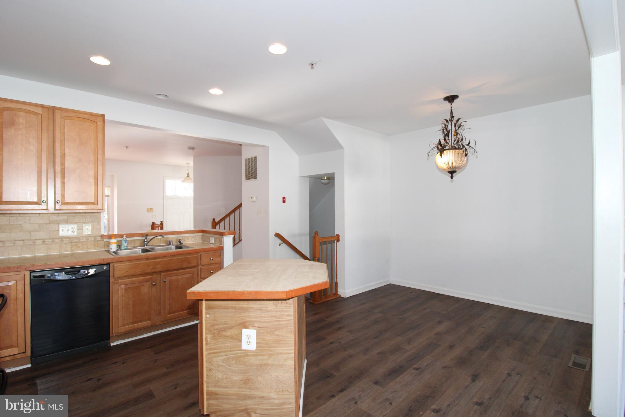 17628 Basalt Way Hagerstown, MD 21740 - Photo 6 of 20 a kitchen with kitchen island a sink and wooden floor
