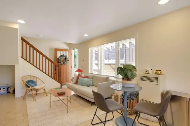 a living room with furniture and a potted plant