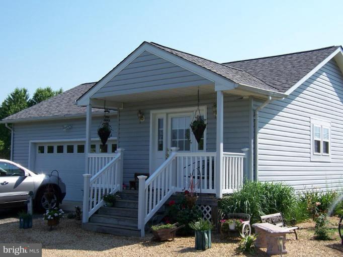 6843 Old Solomons Island Road Friendship, MD 20736 - Photo 2 of 20 a view of a house with wooden deck and furniture