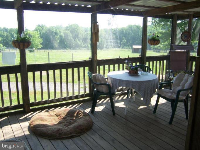 6843 Old Solomons Island Road Friendship, MD 20736 - Photo 13 of 20 a dining room with furniture window and wooden floor