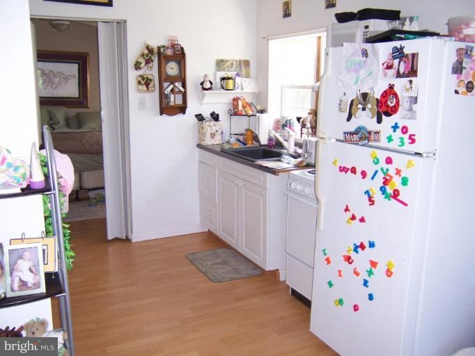 6843 Old Solomons Island Road Friendship, MD 20736 - Photo 14 of 20 a white refrigerator with lots of clutter on it
