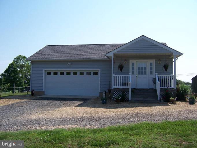 6843 Old Solomons Island Road Friendship, MD 20736 - Photo 3 of 20 a front view of a house with a yard