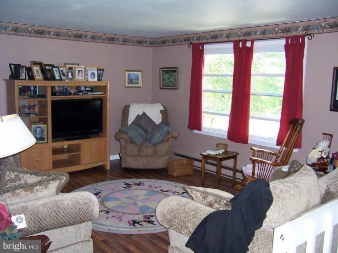 6843 Old Solomons Island Road Friendship, MD 20736 - Photo 10 of 20 a living room with furniture and a flat screen tv