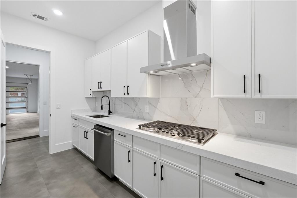 1563 Whitley Road Dacula, GA 30019 - Photo 14 of 44 a kitchen with white cabinets and appliances