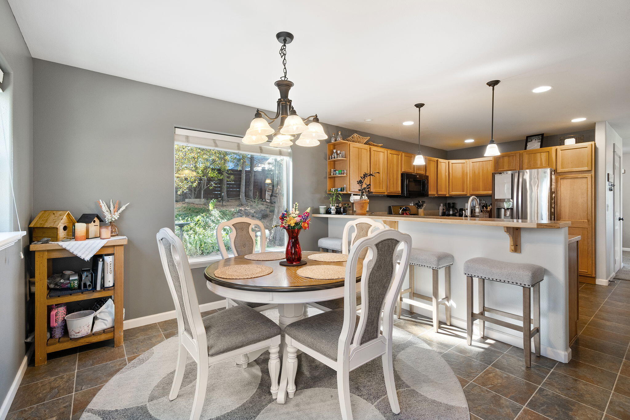62906 Bilyeu Way Bend, OR 97701 - Photo 13 of 100 a dining room with furniture and a kitchen view