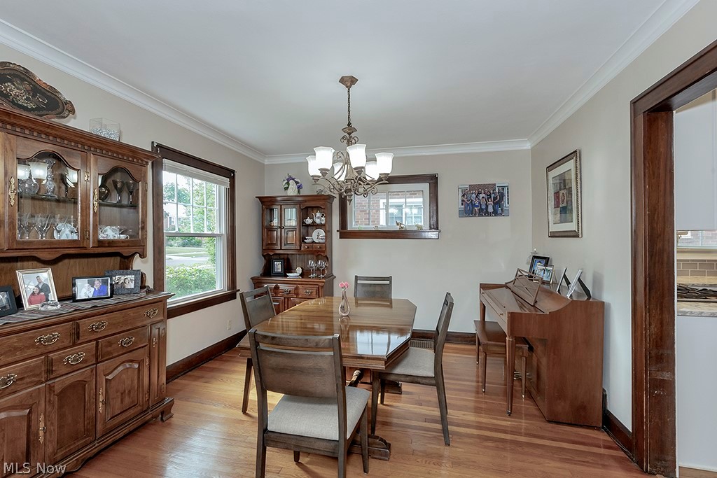 2480 Eaton Road Cleveland, OH 44118 - Photo 10 of 41 Dining room featuring an inviting chandelier, hardwood / wood-style flooring, and crown molding