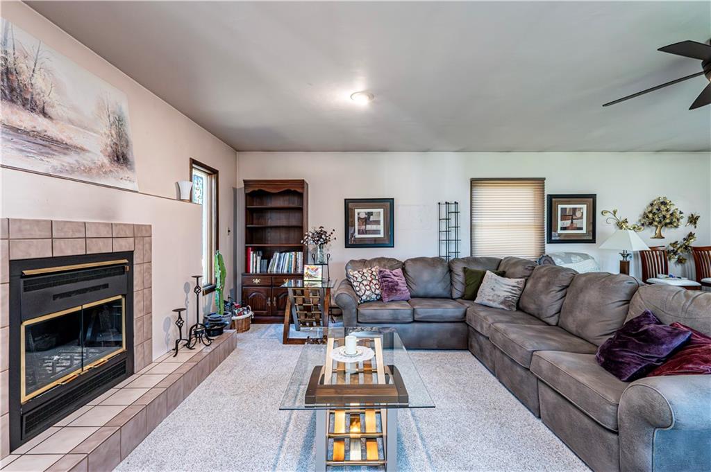 2037 Ridge Road Jeannette, PA 15644 - Photo 13 of 24 a living room with furniture a fireplace and a flat screen tv