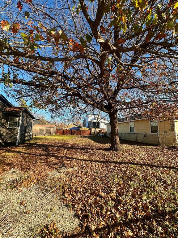 3346 Parvia Avenue Dallas, TX 75212 - Photo 5 of 5 a wooden bench sitting in middle of a yard