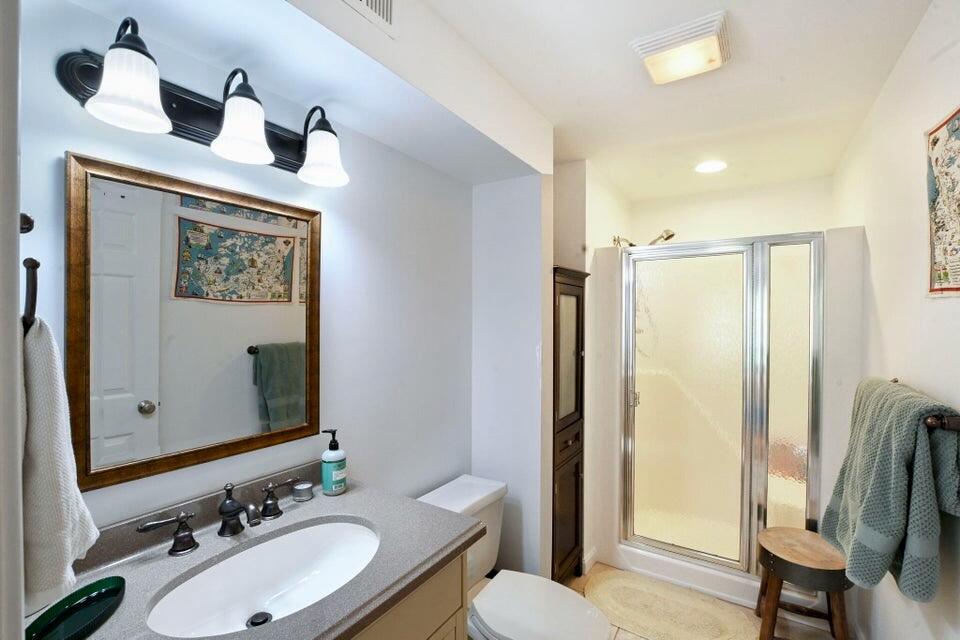 38 Landfall, Unit 38 Falmouth, MA 02540 - Photo 13 of 17 a bathroom with a sink vanity mirror and toilet