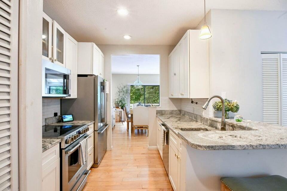 38 Landfall, Unit 38 Falmouth, MA 02540 - Photo 4 of 17 a kitchen with a sink stove and cabinets