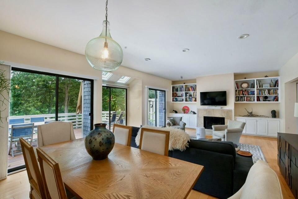 38 Landfall, Unit 38 Falmouth, MA 02540 - Photo 7 of 17 a living room with fireplace furniture and a flat screen tv