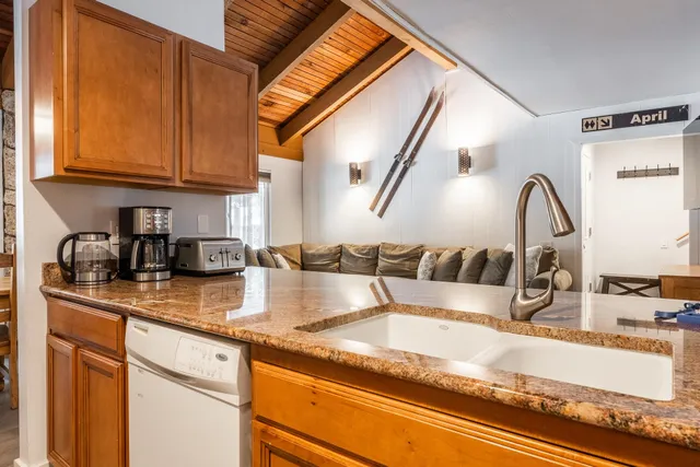 a view of a kitchen with granite countertop a sink and a granite counter top