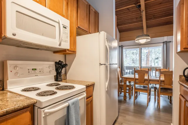a kitchen with a stove and white cabinets