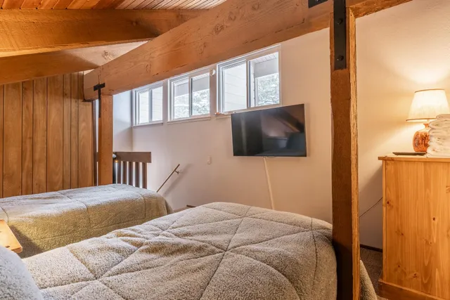 a bedroom with a bed and a flat screen tv
