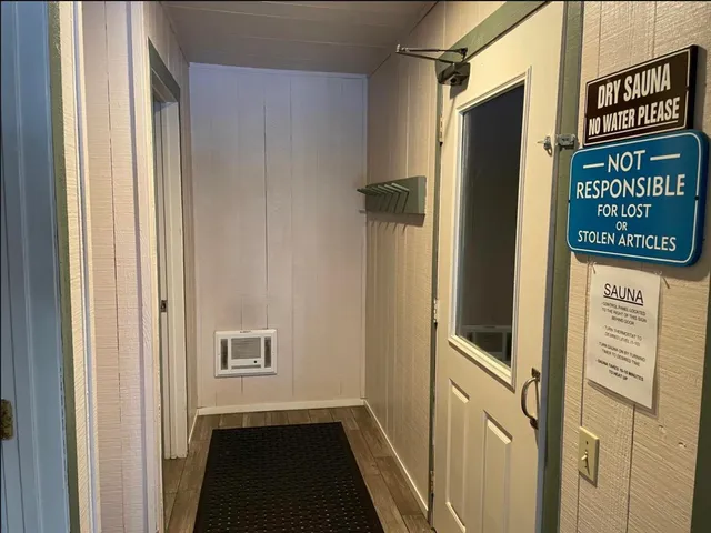 a view of a hallway with wooden door