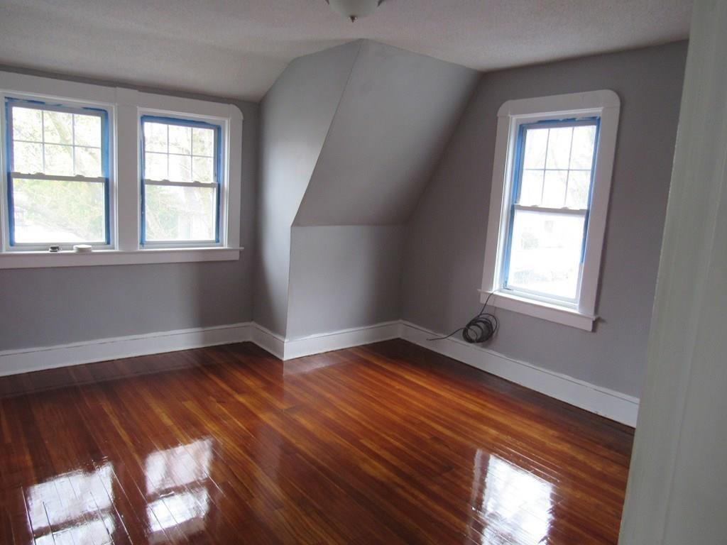 71 Meredith Street Springfield, MA 01108 - Photo 17 of 27 a view of an empty room with wooden floor and a window