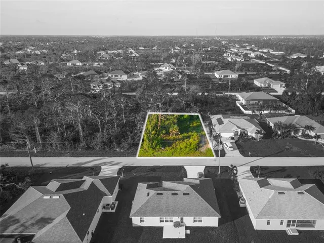 an aerial view of residential houses with yard