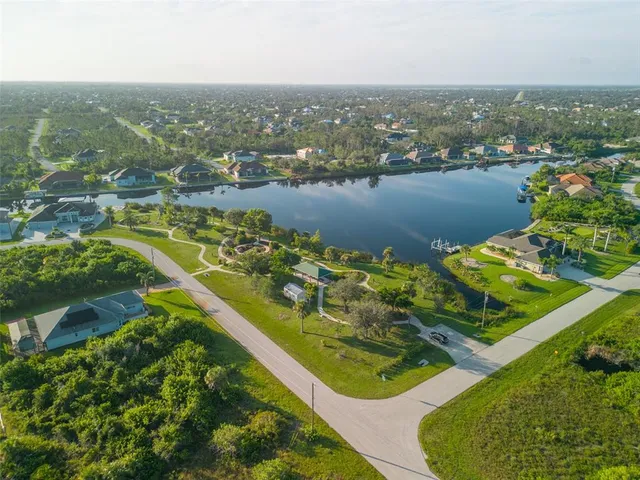 an aerial view of residential houses with outdoor space and river