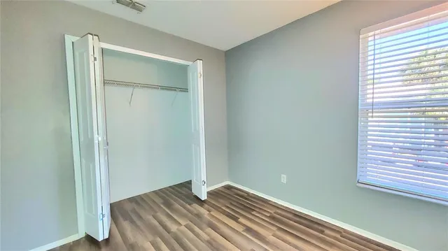 a view of room with wooden floor