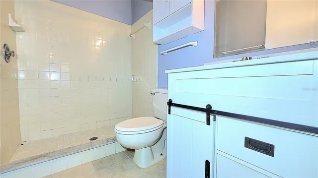 a white toilet sitting next to a bath tub