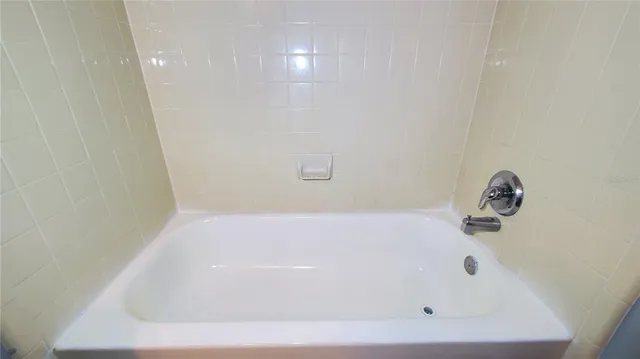 a view of a room with wooden floor and a window