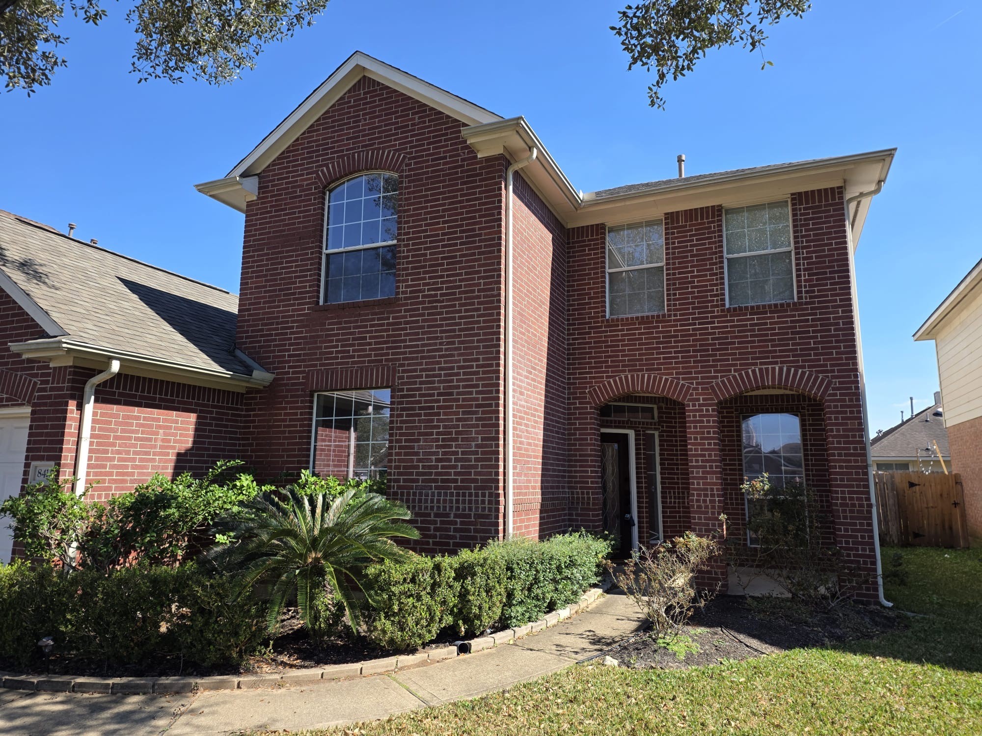 8411 Spotslyvania Lane Houston, TX 77083 - Photo 2 of 8 a front view of a house with yard