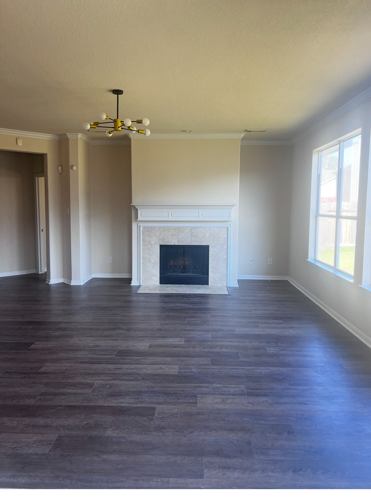 8411 Spotslyvania Lane Houston, TX 77083 - Photo 7 of 8 a view of empty room with wooden floor and fireplace