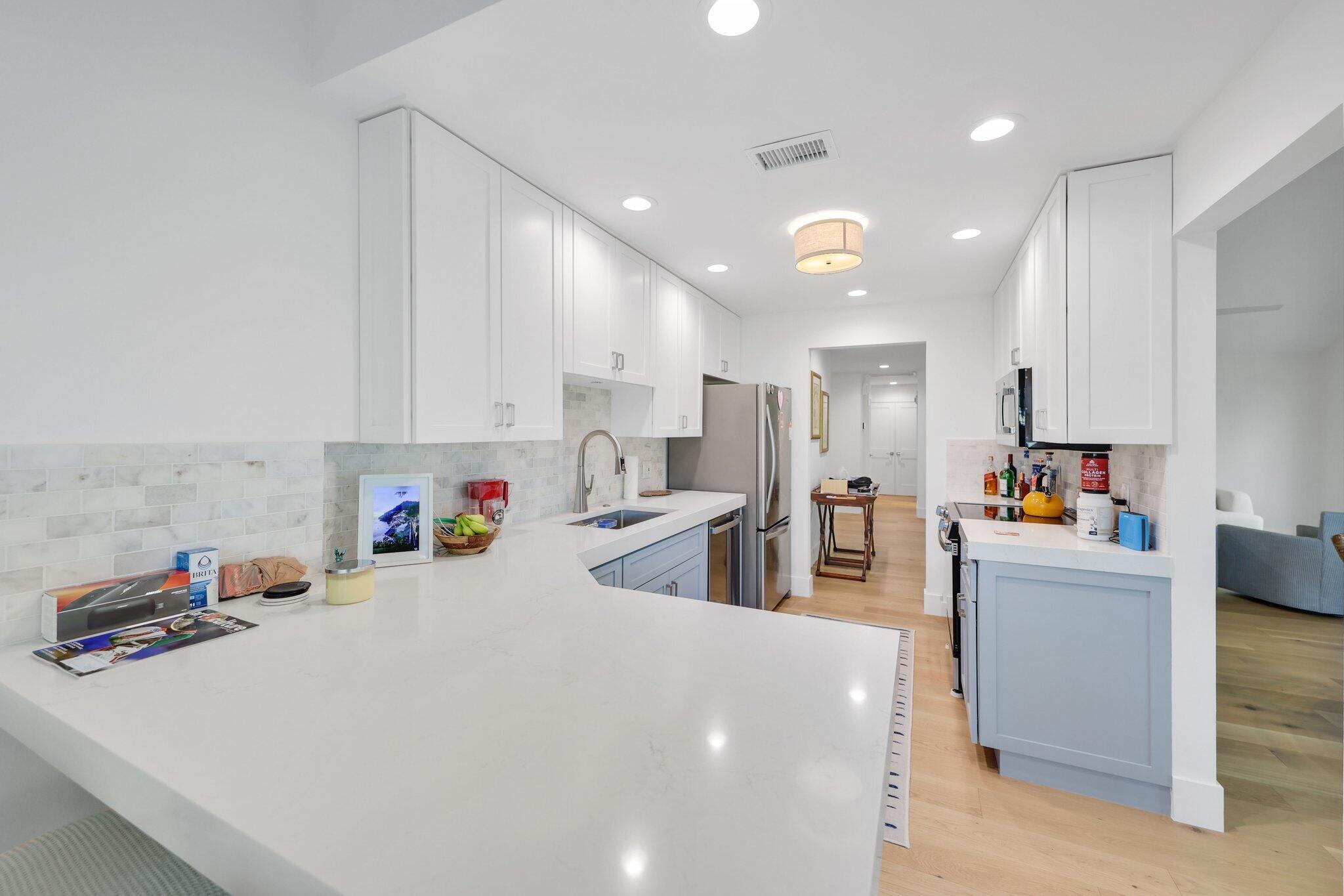 17012 Traverse Circle Jupiter, FL 33477 - Photo 14 of 33 a large white kitchen with lots of counter top space a sink and cabinets
