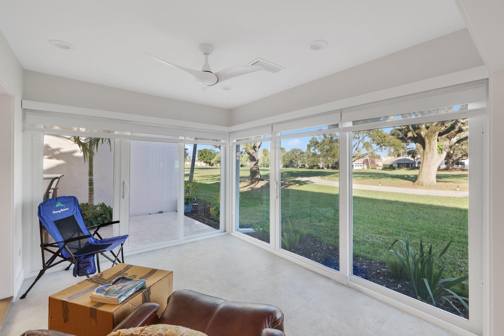 17012 Traverse Circle Jupiter, FL 33477 - Photo 18 of 33 a living room with furniture and a floor to ceiling window