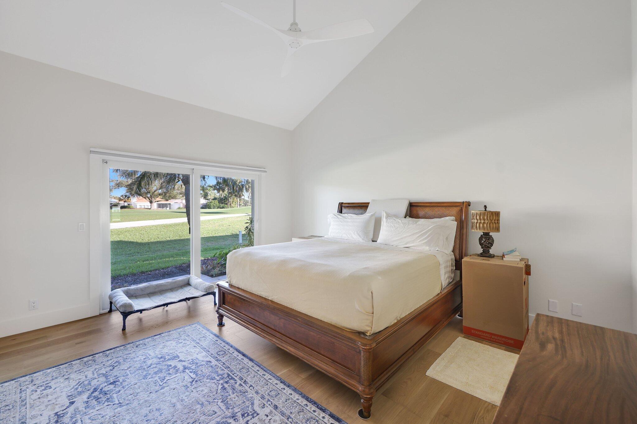 17012 Traverse Circle Jupiter, FL 33477 - Photo 21 of 33 a bed sitting in a bedroom next to a window