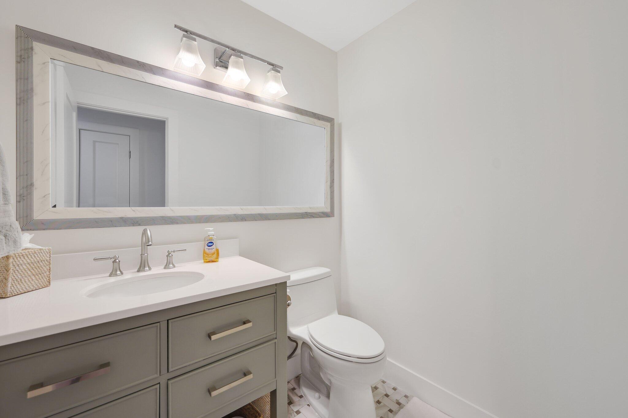 17012 Traverse Circle Jupiter, FL 33477 - Photo 26 of 33 a bathroom with a sink a toilet and mirror