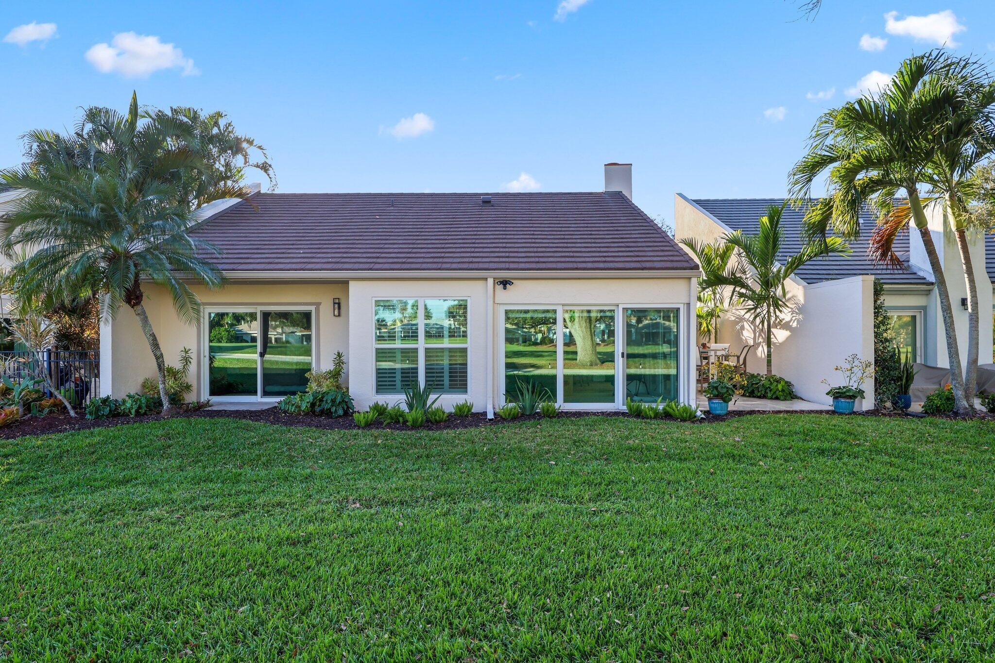 17012 Traverse Circle Jupiter, FL 33477 - Photo 33 of 33 a view of a house with a yard and potted plants