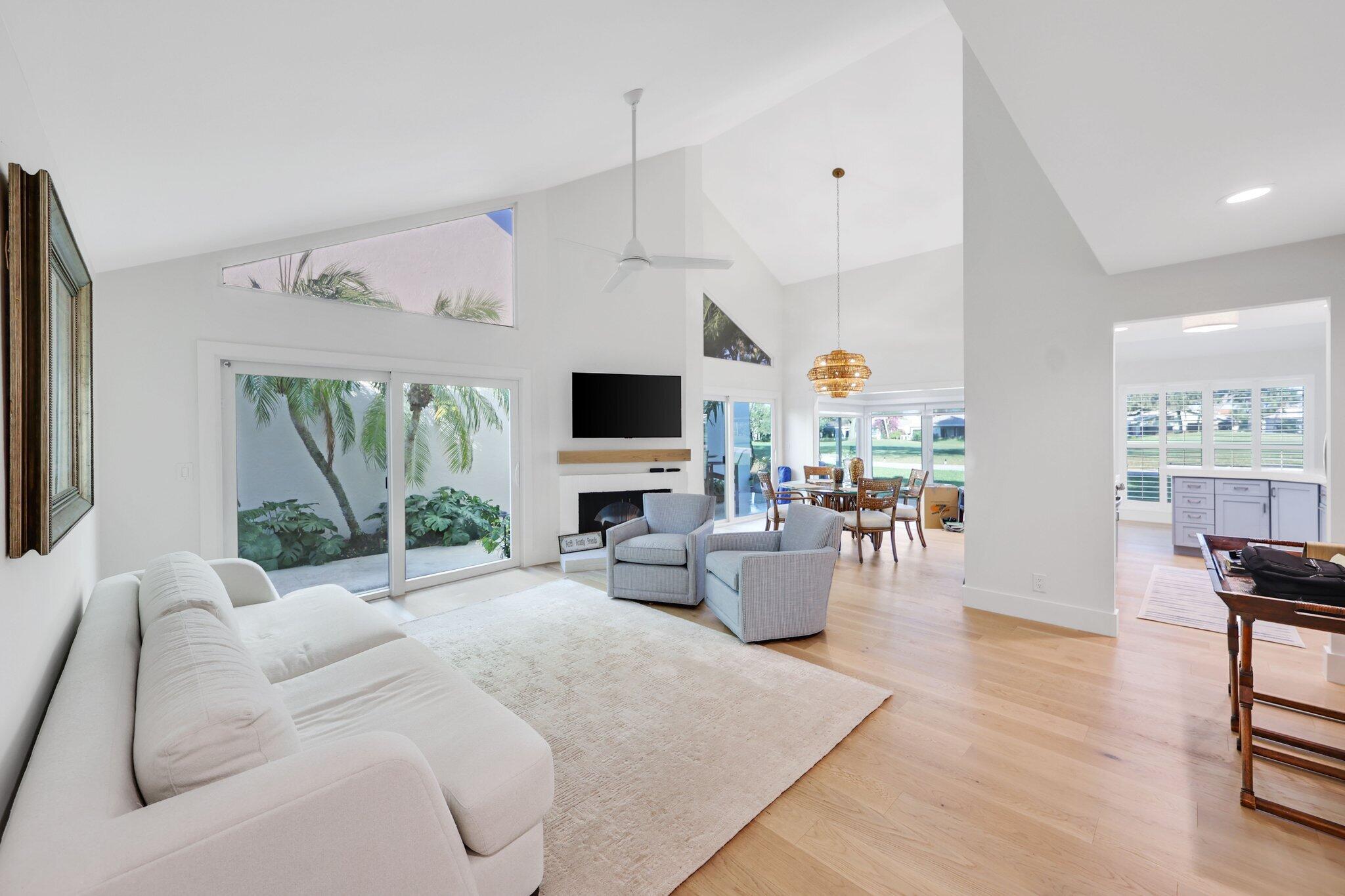 17012 Traverse Circle Jupiter, FL 33477 - Photo 5 of 33 a living room with furniture a flat screen tv and a large window
