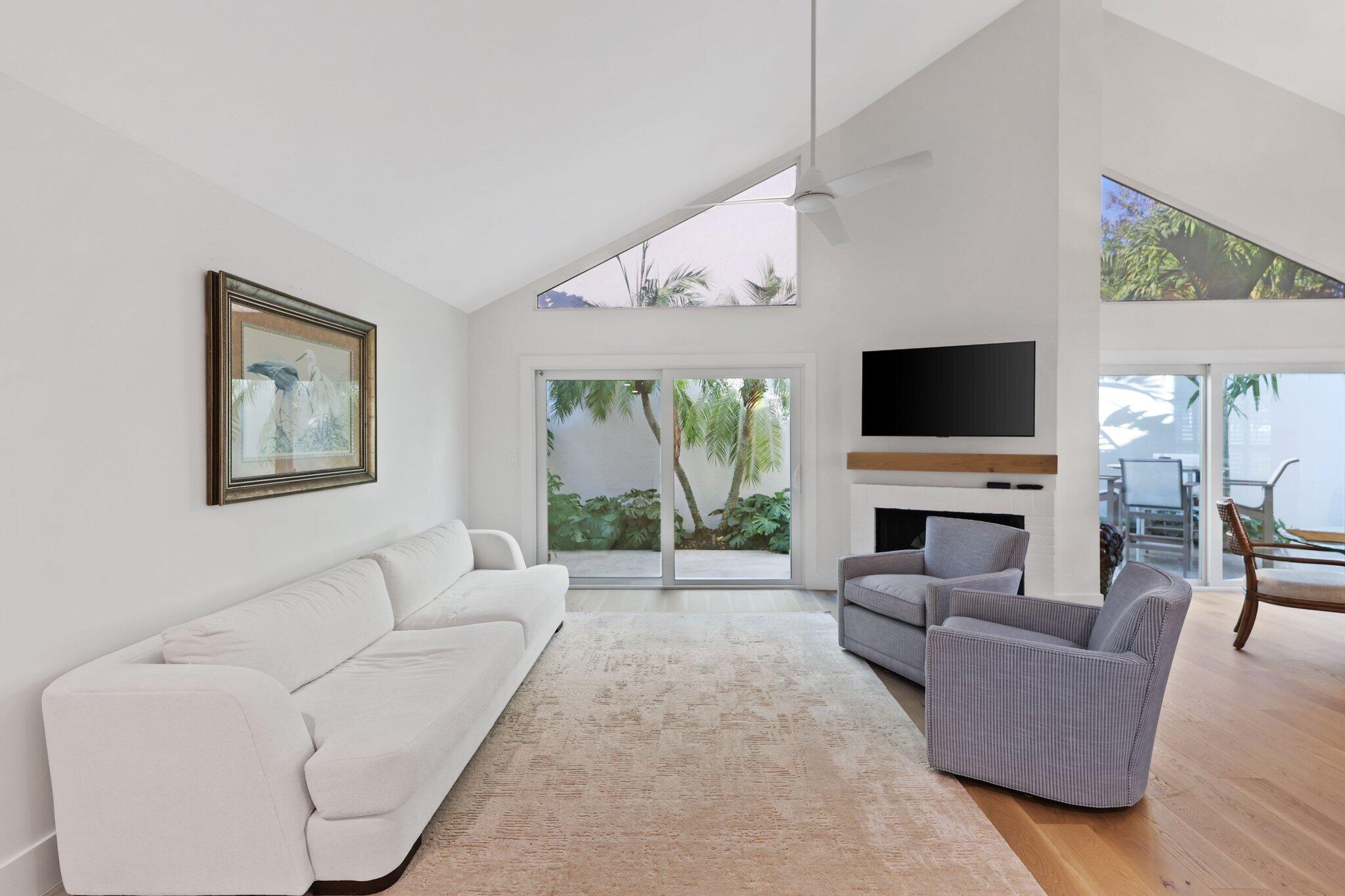 17012 Traverse Circle Jupiter, FL 33477 - Photo 9 of 33 a living room with furniture a flat screen tv and a fireplace