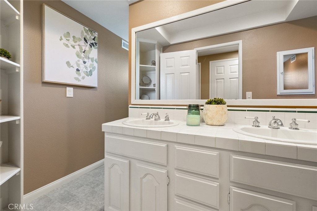 1940 Sunset Lane Fullerton, CA 92833 - Photo 30 of 50 a bathroom with a sink and a mirror