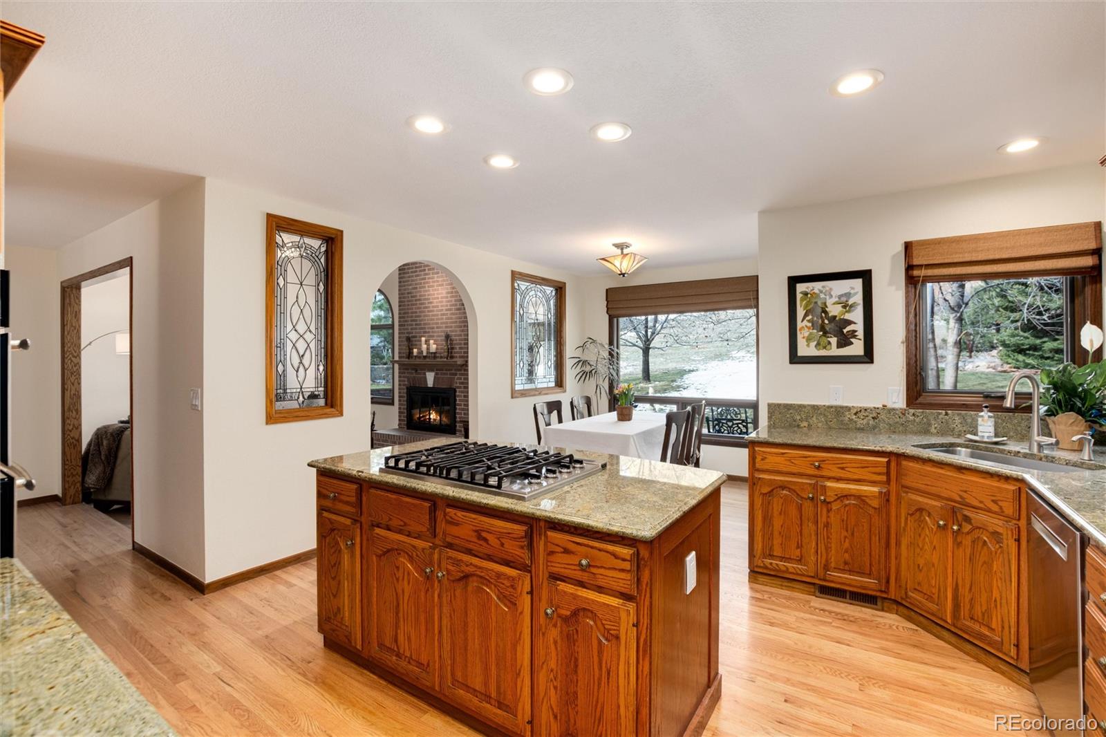 65 North Ranch Road Littleton, CO 80127 - Photo 11 of 44 a kitchen with stainless steel appliances granite countertop a stove a sink dishwasher and a refrigerator with wooden floor