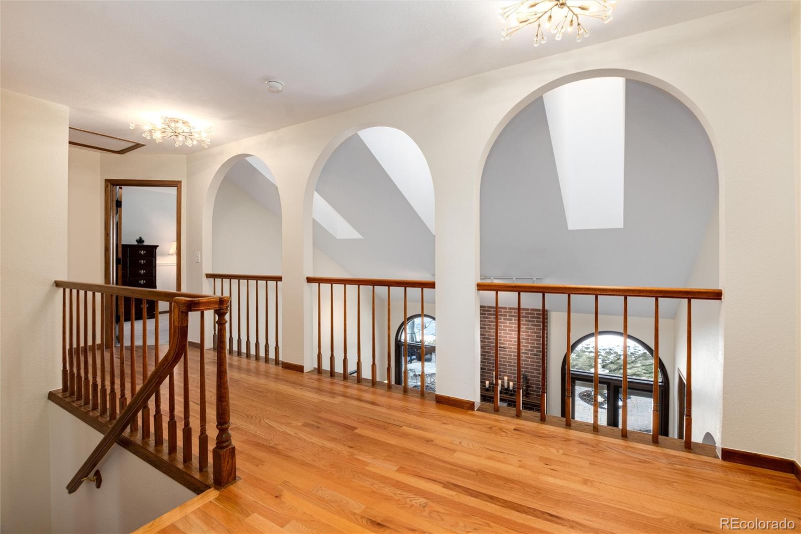 65 North Ranch Road Littleton, CO 80127 - Photo 14 of 44 a view of a hallway with entryway wooden floor and door