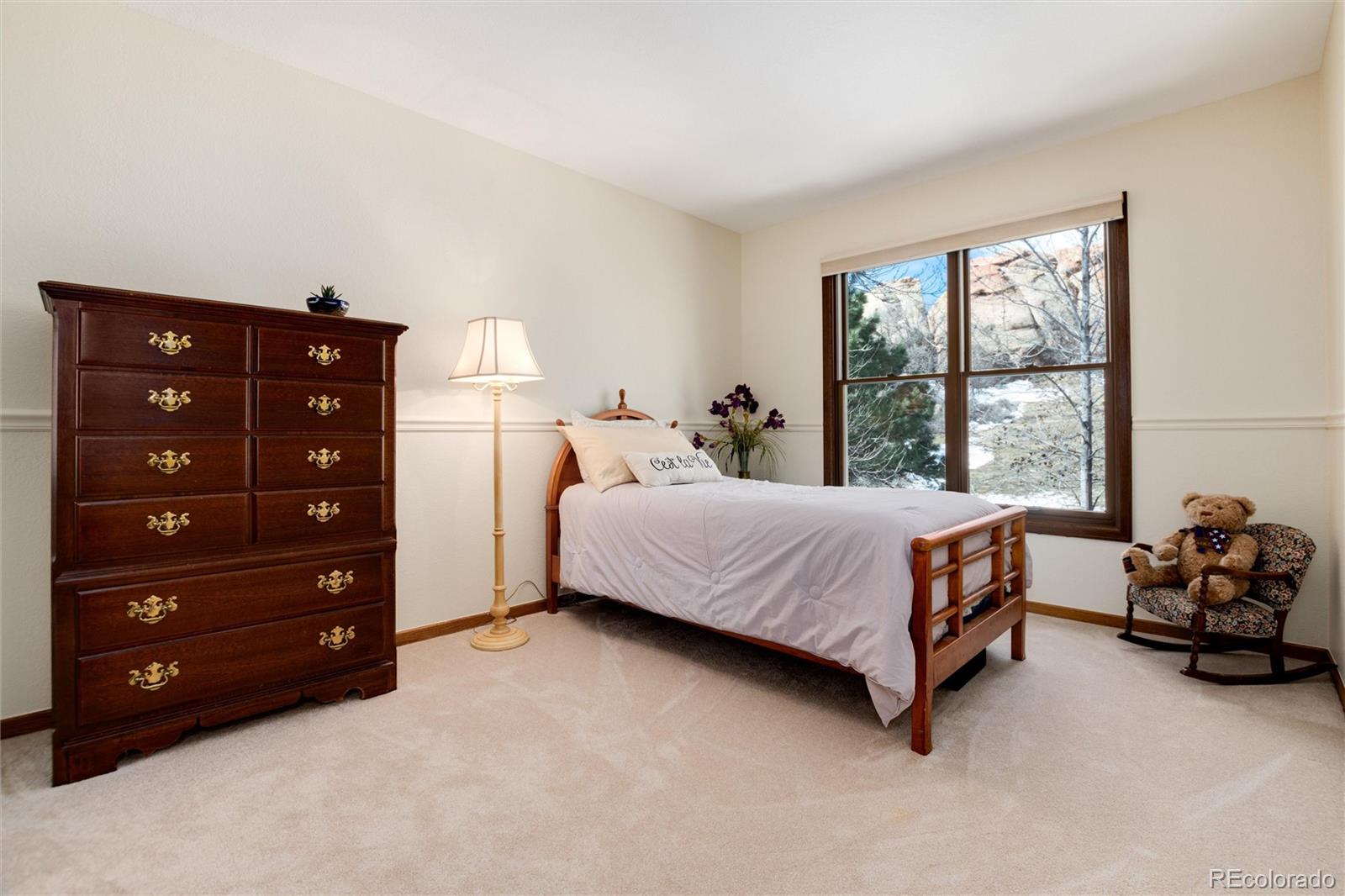 65 North Ranch Road Littleton, CO 80127 - Photo 19 of 44 a bedroom with a bed and a dresser