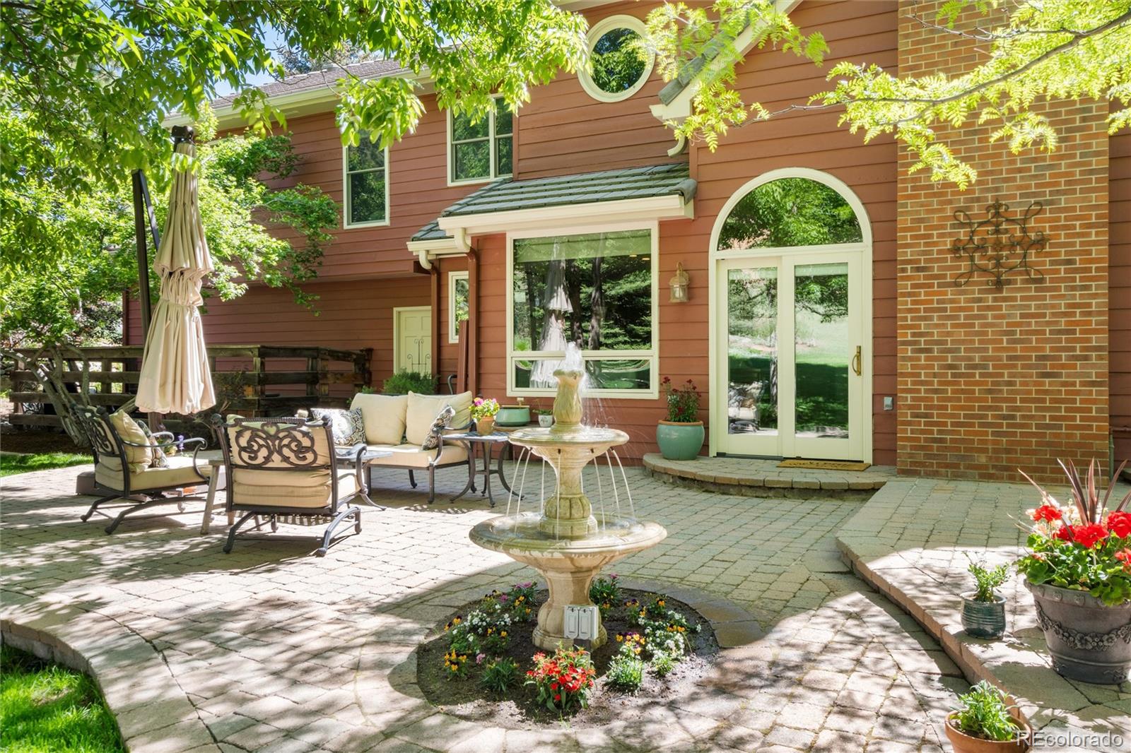 65 North Ranch Road Littleton, CO 80127 - Photo 2 of 44 a view of a house with backyard sitting area and garden