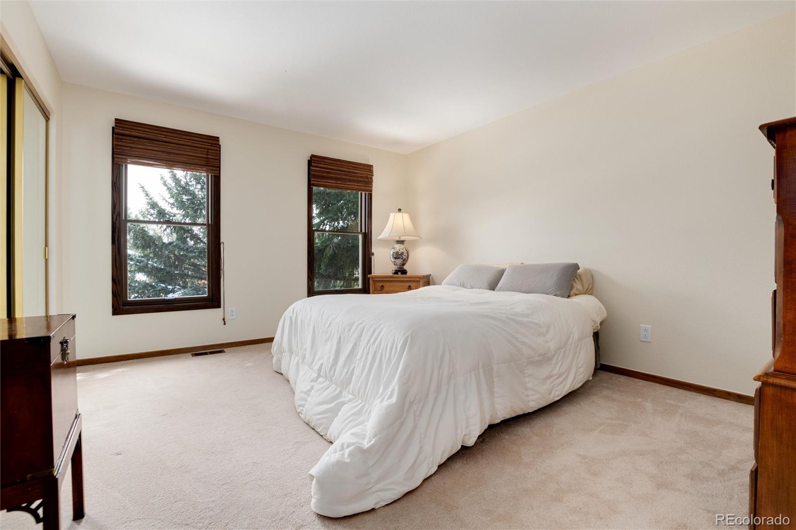 65 North Ranch Road Littleton, CO 80127 - Photo 22 of 44 a bedroom with a bed and windows